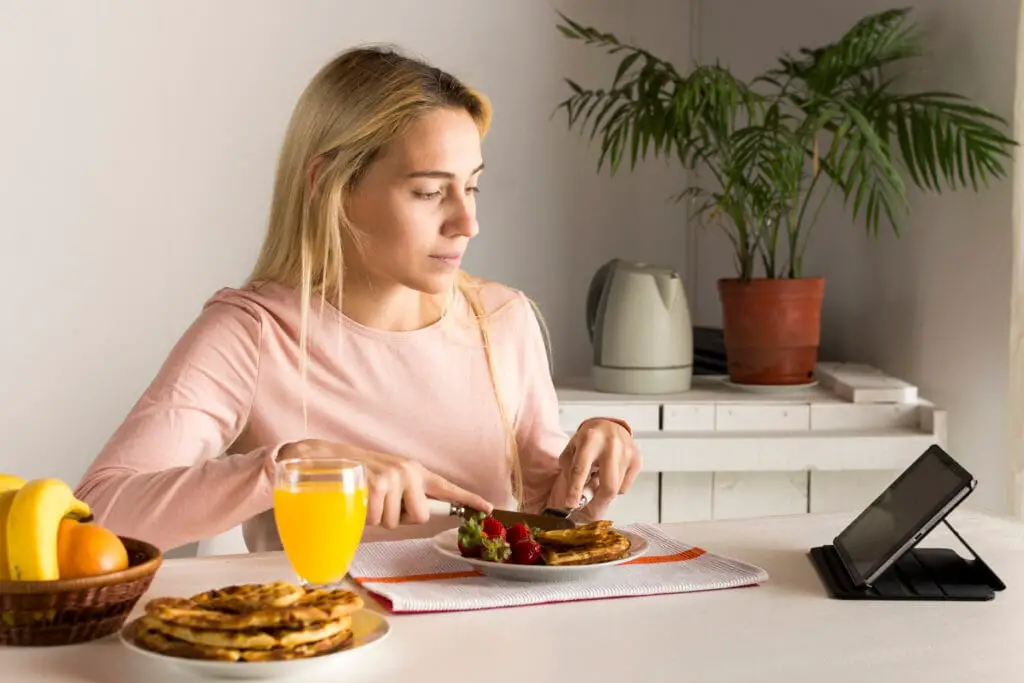Why High-Protein Breakfasts Matter for Busy People 1 Bin Recipes girl having waffles watching tablet Bin Recipes