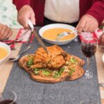 old man cutting baked chicken festive table 23 2147973677 Bin Recipes