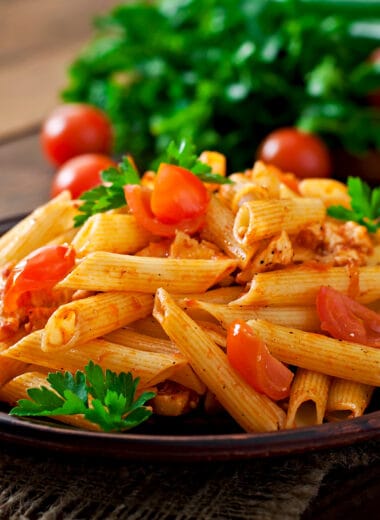 penne pasta tomato sauce with chicken tomatoes wooden table Bin Recipes