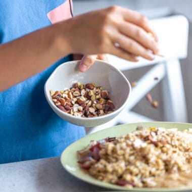 woman prepares oatmeal with fruits closeup Bin Recipes