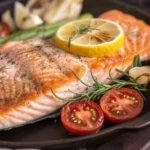 Plate of high protein foods for weight loss including fish, nuts, and legumes.